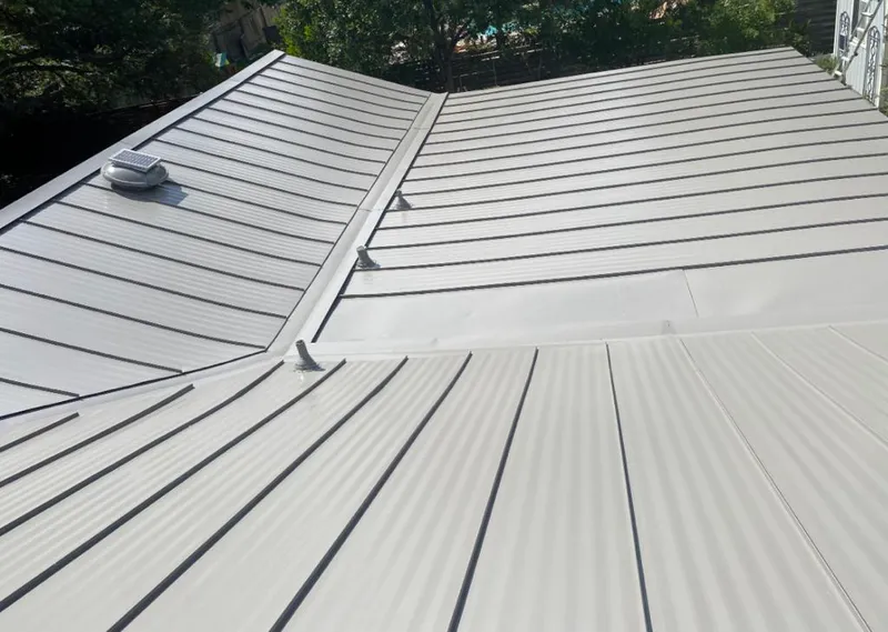 Solar attic fan installed on a metal roof for Roof Ventilation in Fayetteville